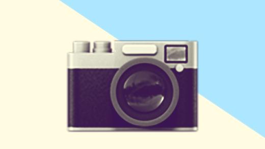 A duotoned dark purple and beige version of the Apple camera emoji upside down, in front of a blue triangle across the top right corner